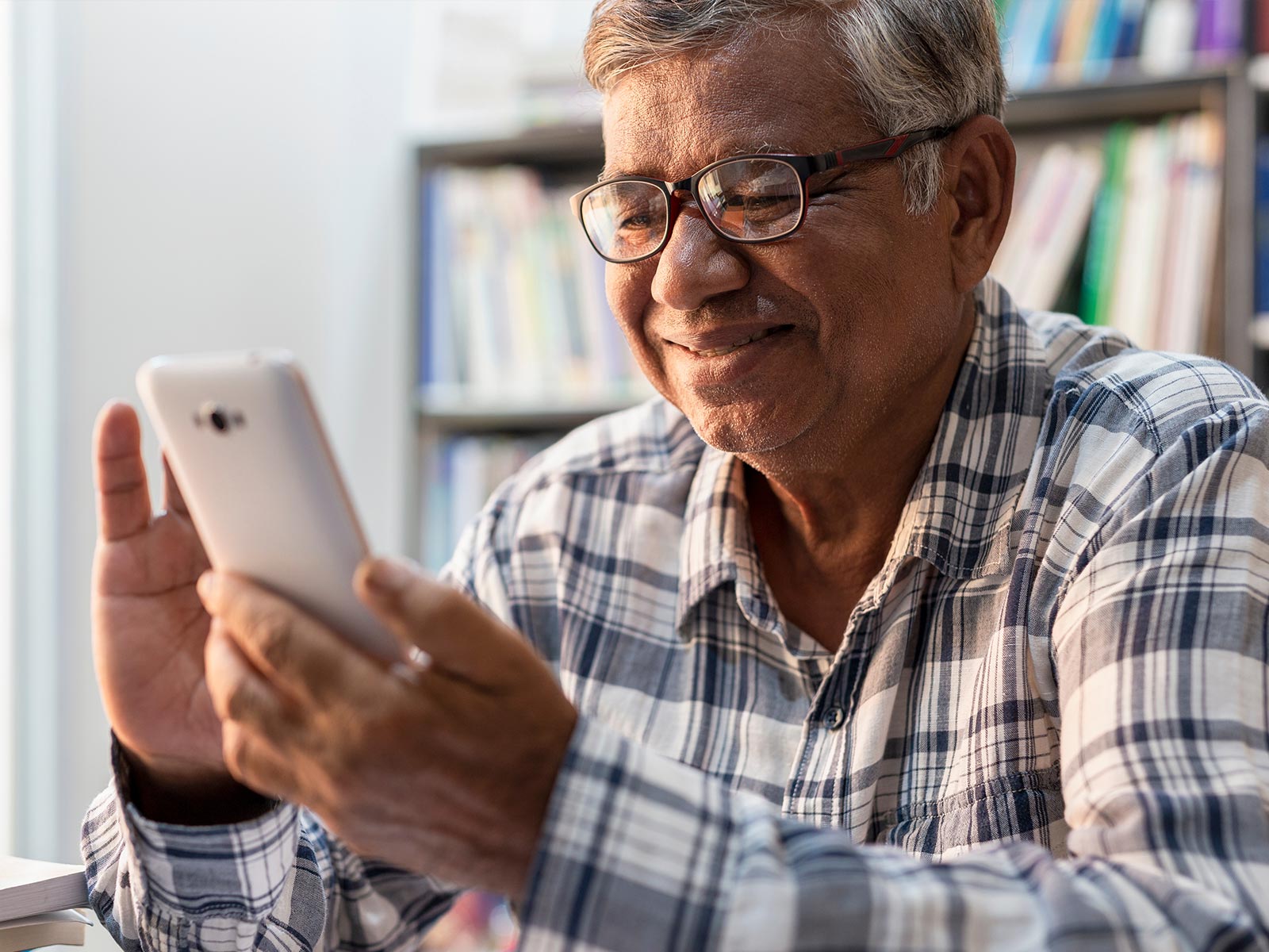 An older man using his phone.