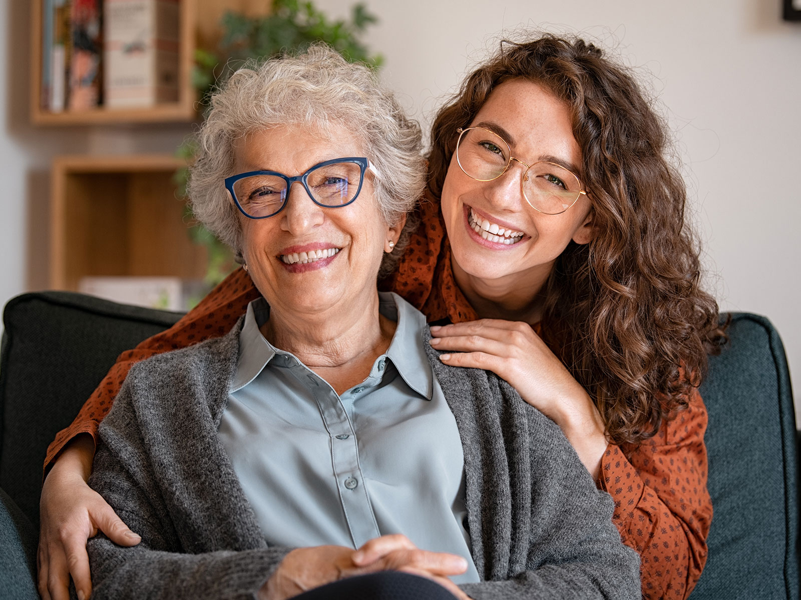 An older and younger woman smiling