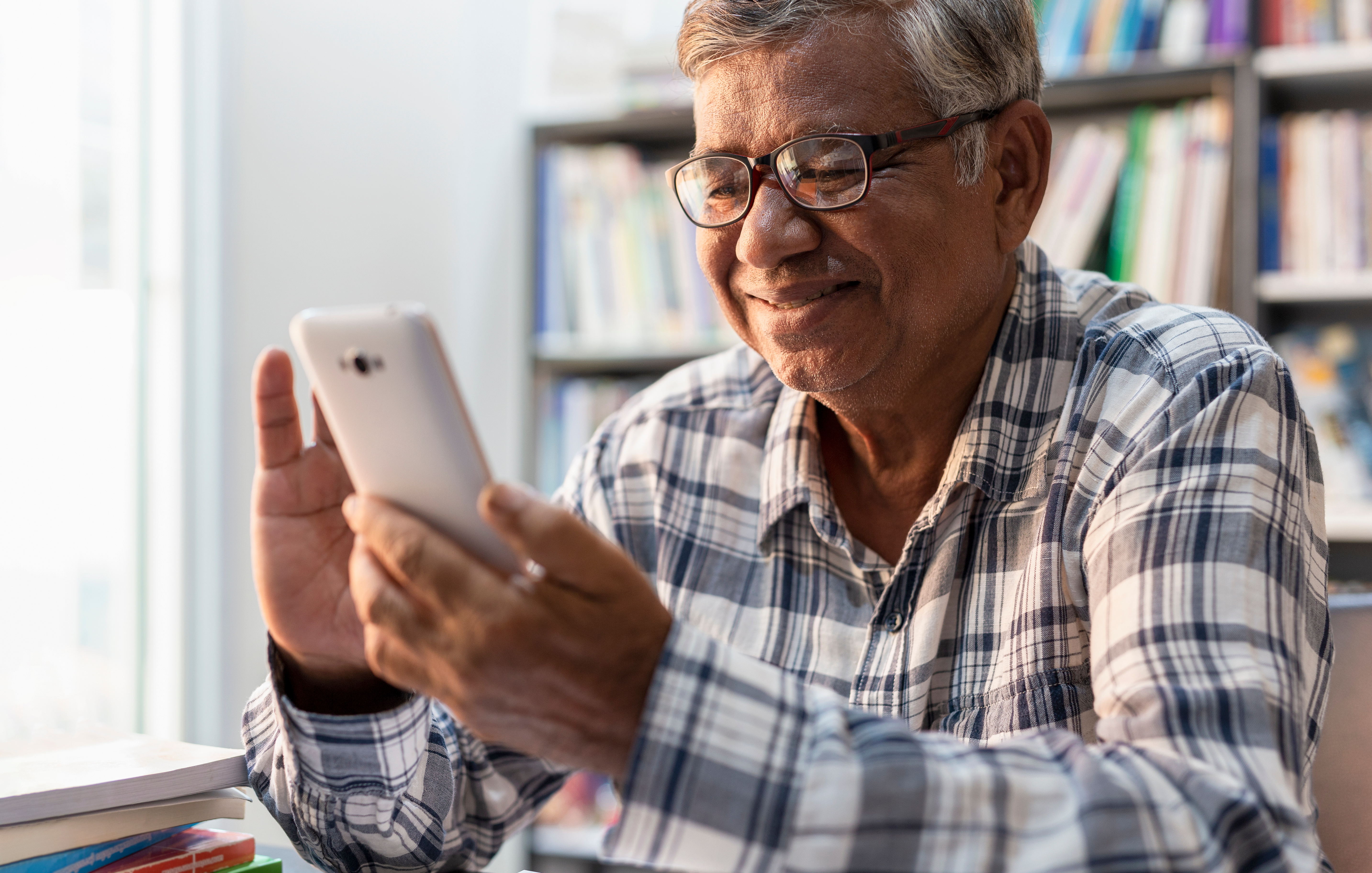 An older man using his phone.