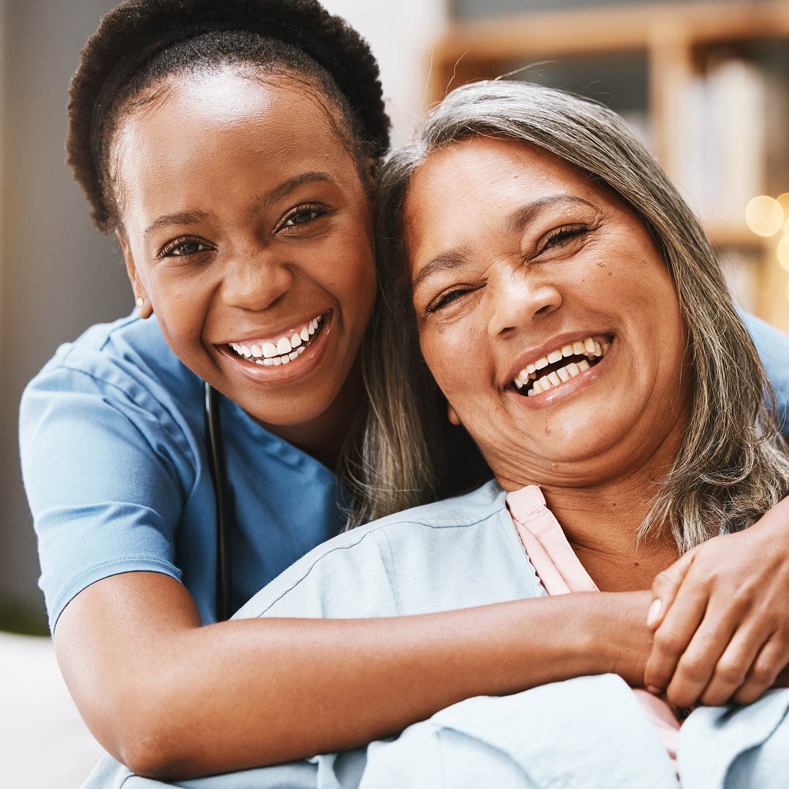 A caregiver smiling with an older woman.