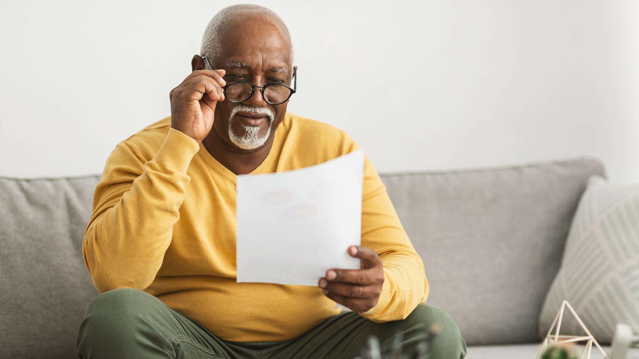 Man peruses insurance from comfort of his couch