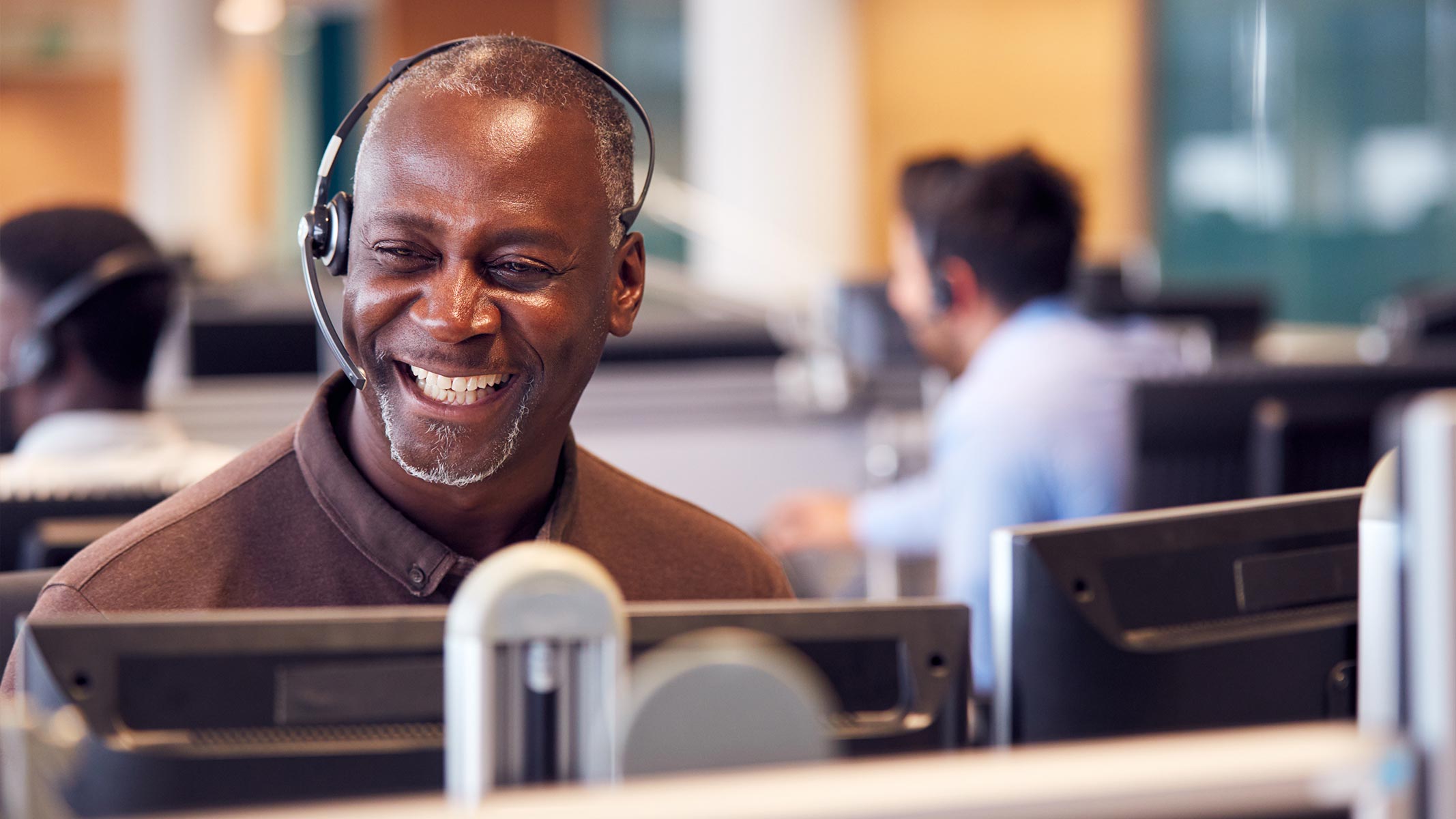 A customer services representative smiling.