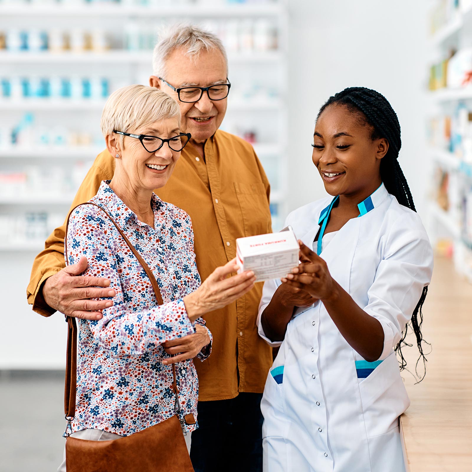 Pharmacist helping couple at store