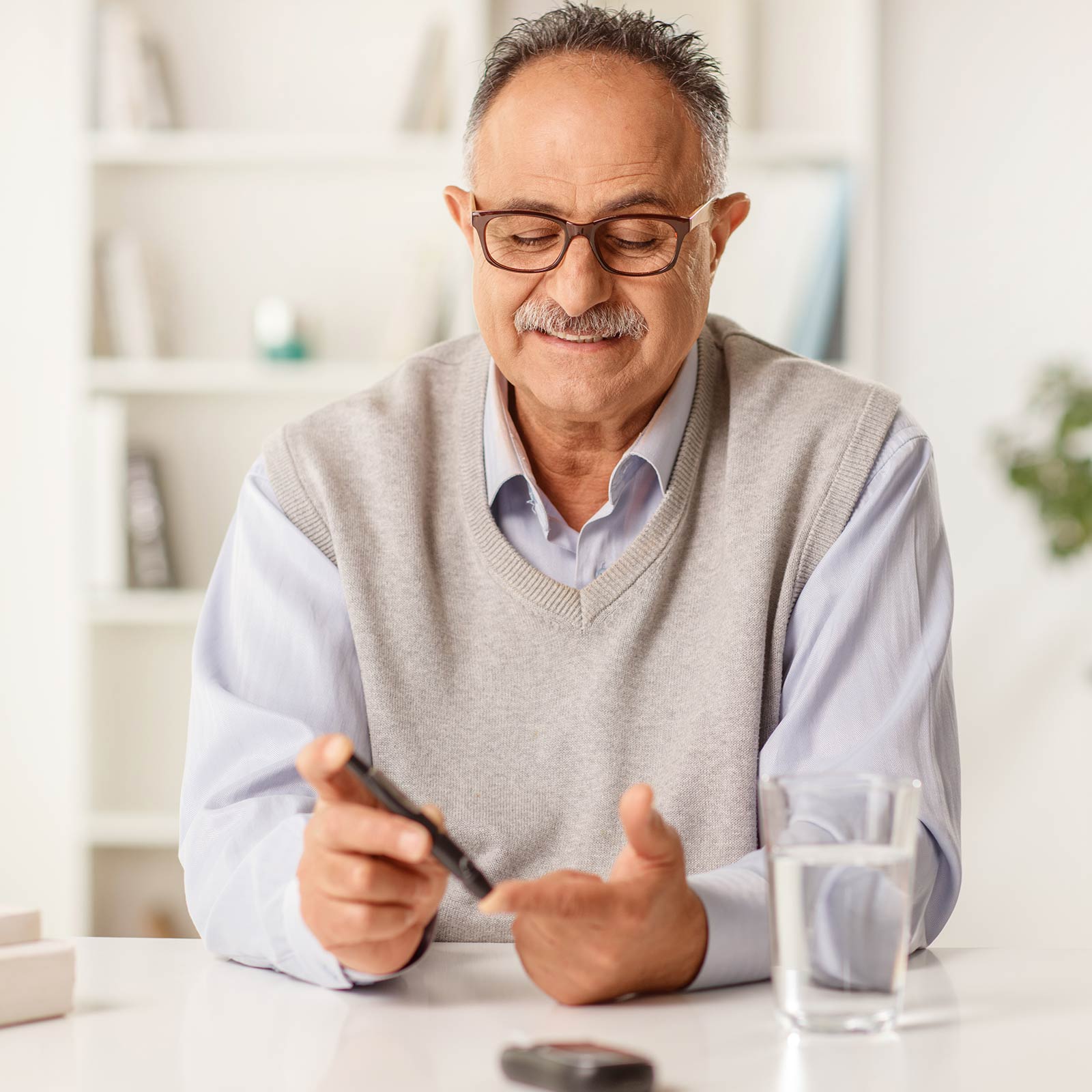 Older man testing his blood sugar level.