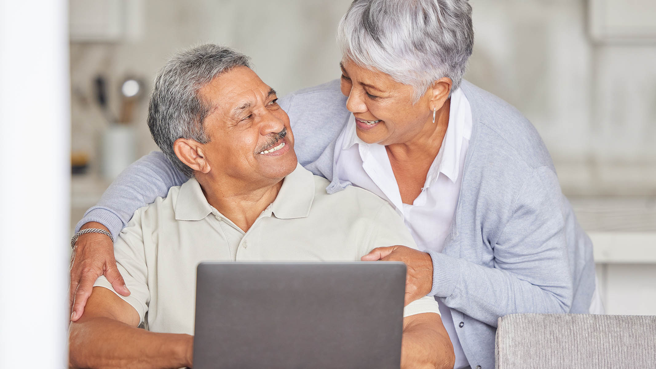 Older couple looking at each other and smiling.